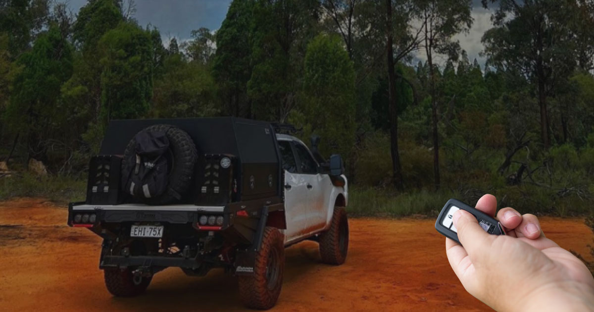 Person using a key to unlock UTE toolbox canopy